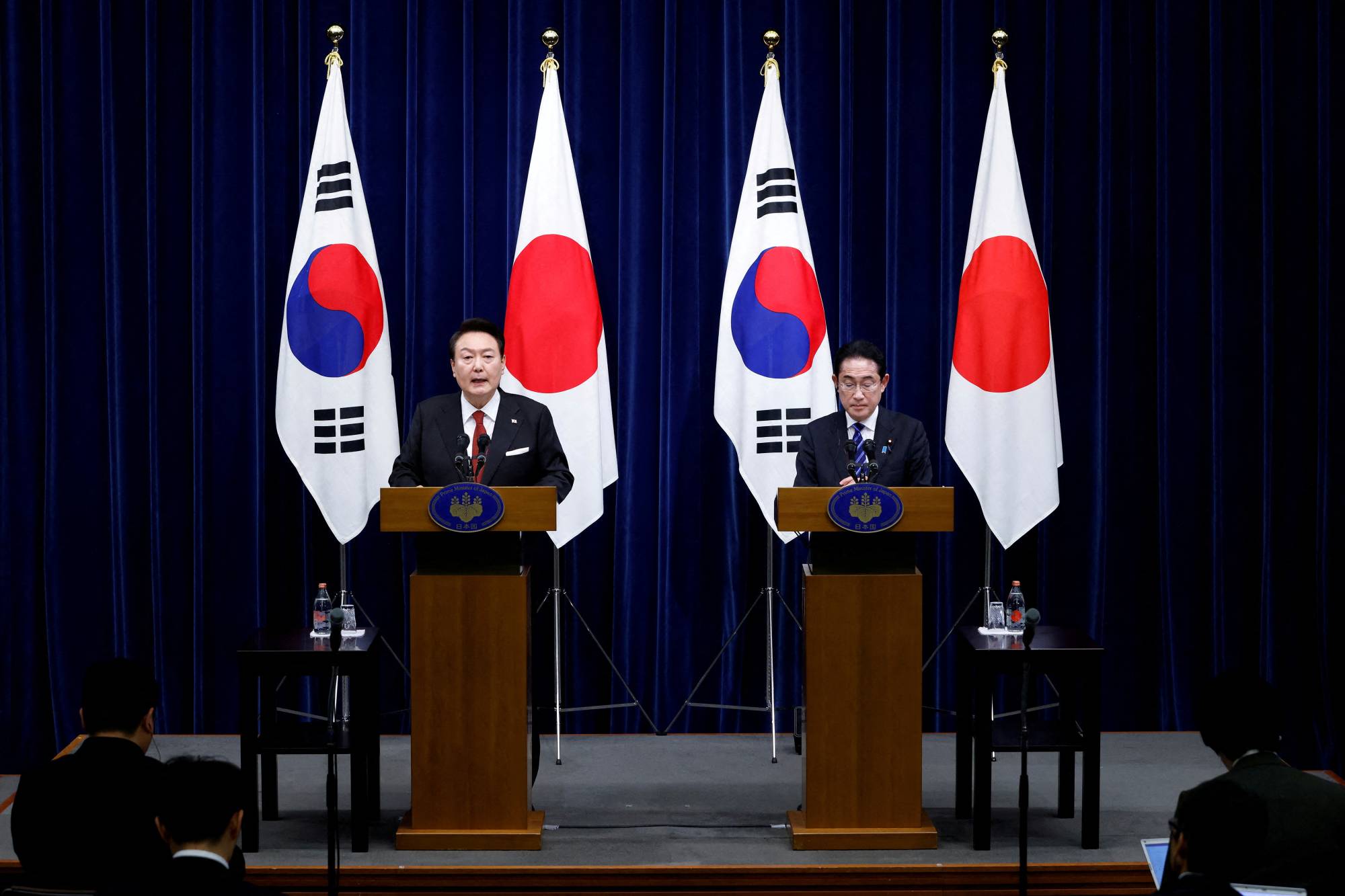 Prime Minister Fumio Kishida and South Korean President Yoon Suk-yeol hold a joint news conference at the Prime Minister's Office in Tokyo on March 16. | POOL / VIA REUTERS