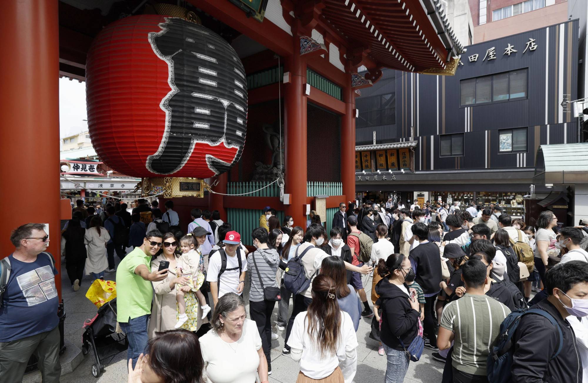 The Asakusa district in Tokyo on April 29. With the change to COVID-19's classification, the government will lose the legal basis to declare a state of emergency or quasi-state of emergency, and will not ask infected people or their close contacts to restrict their movements. | KYODO