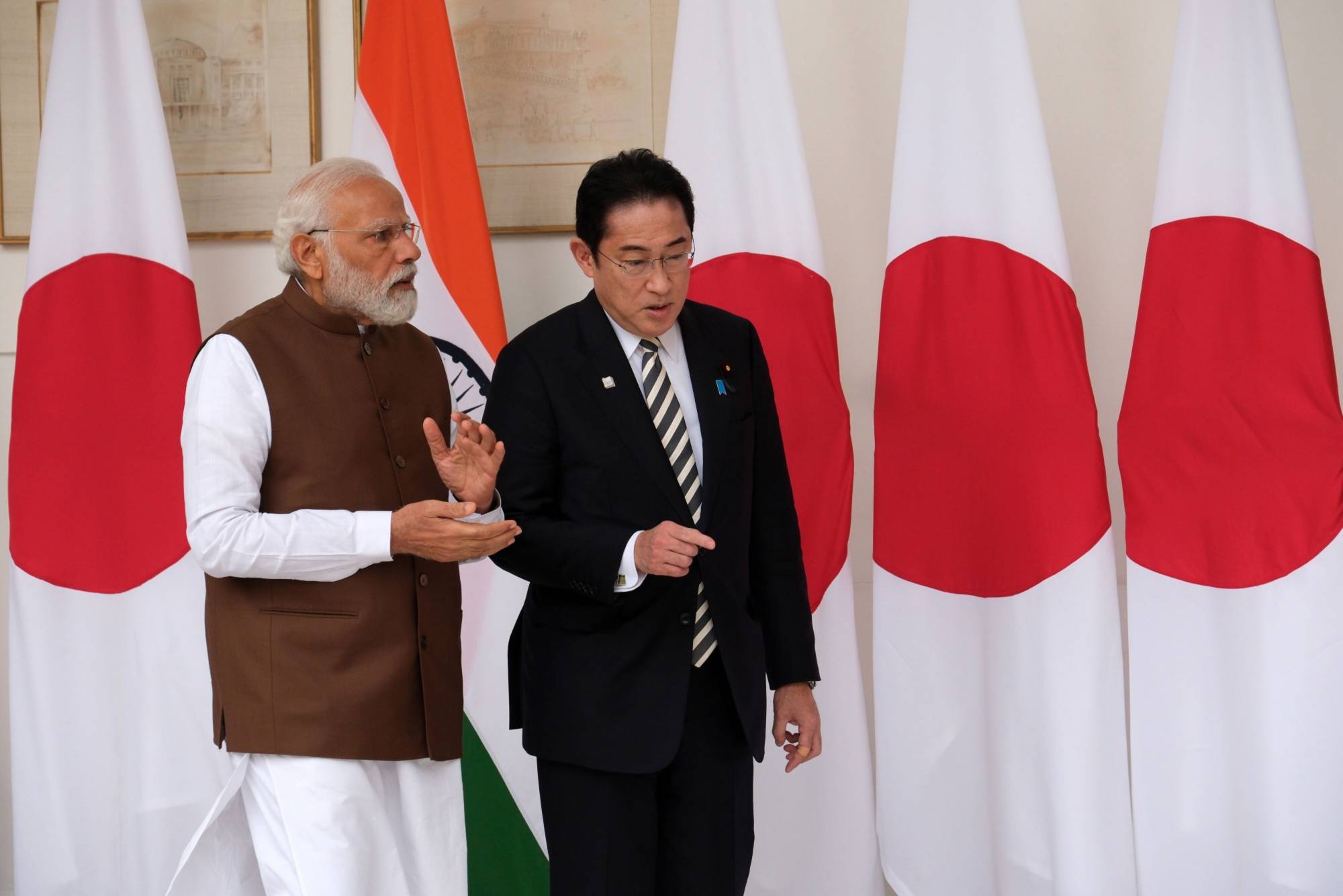 Indian leader Narendra Modi and Prime Minister Fumio Kishida chat ahead of their meeting in New Delhi on March 20. | BLOOMBERG