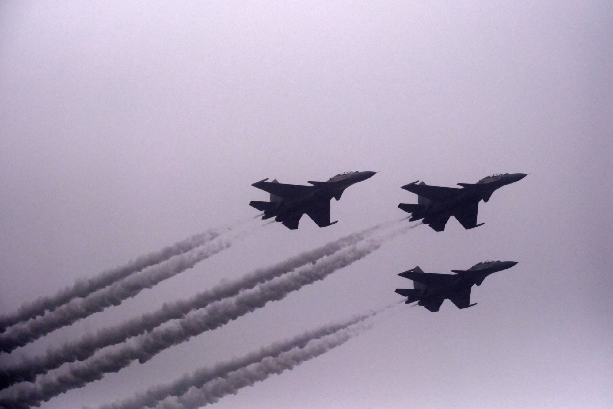 Indian Air Force’s Russian-designed Su-30 MKI fighter jets fly over New Delhi. | Bloomberg