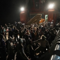 Civilians wait at sea port to be evacuated by Saudi Arabia from Sudan to escape the conflicts, in Port Sudan, Sudan, on Sunday | REUTERS