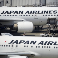 Cargo is loaded onto a Japan Airlines aircraft at Haneda Airport in Tokyo. JAL plans to introduce three new dedicated cargo planes this fiscal year to meet increasing demand in the international e-commerce industry. | BLOOMBERG