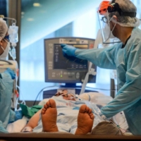 Nurses check a patient infected with COVID-19 at the Guillermo Grant Benavente Hospital in Concepcion, Chile, in April 2021.  | AFP-JIJI