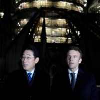 French President Emmanuel Macron and Prime Minister Fumio Kishida visit Notre-Dame Cathedral in Paris, in January. | POOL / VIA REUTERS