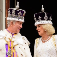 Britain\'s King Charles III looks at Queen Camilla as they stand on the Buckingham Palace balcony, in London, following their coronations, on Saturday. | POOL / VIA AFP-JIJI
