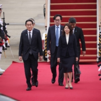 Prime Minister Fumio Kishida and his wife, Yuko, inspect an honor guard upon their arrival at Seoul Air Base in Seongnam, South Korea, on Sunday. | POOL / VIA REUTERS