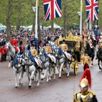 King Charles III and Queen Camilla\'s coronation procession travels to Buckingham Palace along the Mall in London on Saturday.
 | POOL / VIA REUTERS