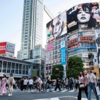 People walk across Shibuya Crossing in Tokyo on Thursday. There were 2,345 new COVID-19 cases  in Tokyo on Sunday, an increase of about 1,300 from a week before. | AFP-JIJI