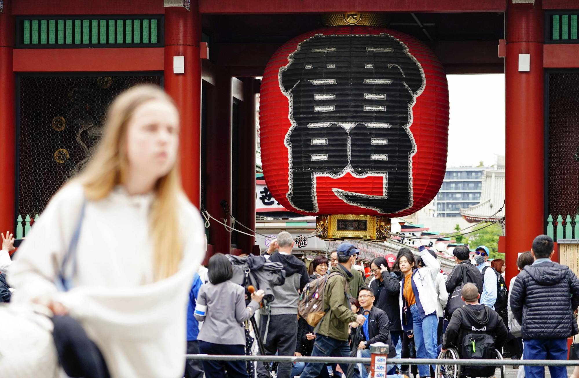 Tourists in Tokyo's Asakusa area on Monday, when Japan downgraded the classification of COVID-19 | KYODO