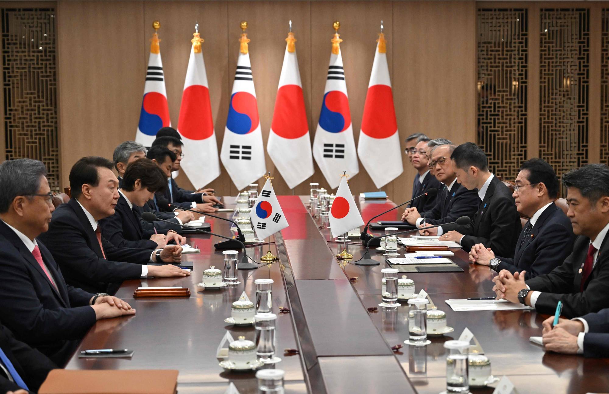 Prime Minister Fumio Kishida meets with South Korean President Yoon Suk-yeol at the Presidential Office in Seoul on Sunday. | POOL / AFP-JIJI