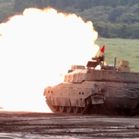 A Ground Self Defense Force Type-10 tank fires a round during an annual training session near Mount Fuji at the Higashifuji training field in Gotemba, Shizuoka Prefecture, in August 2019.  | REUTERS