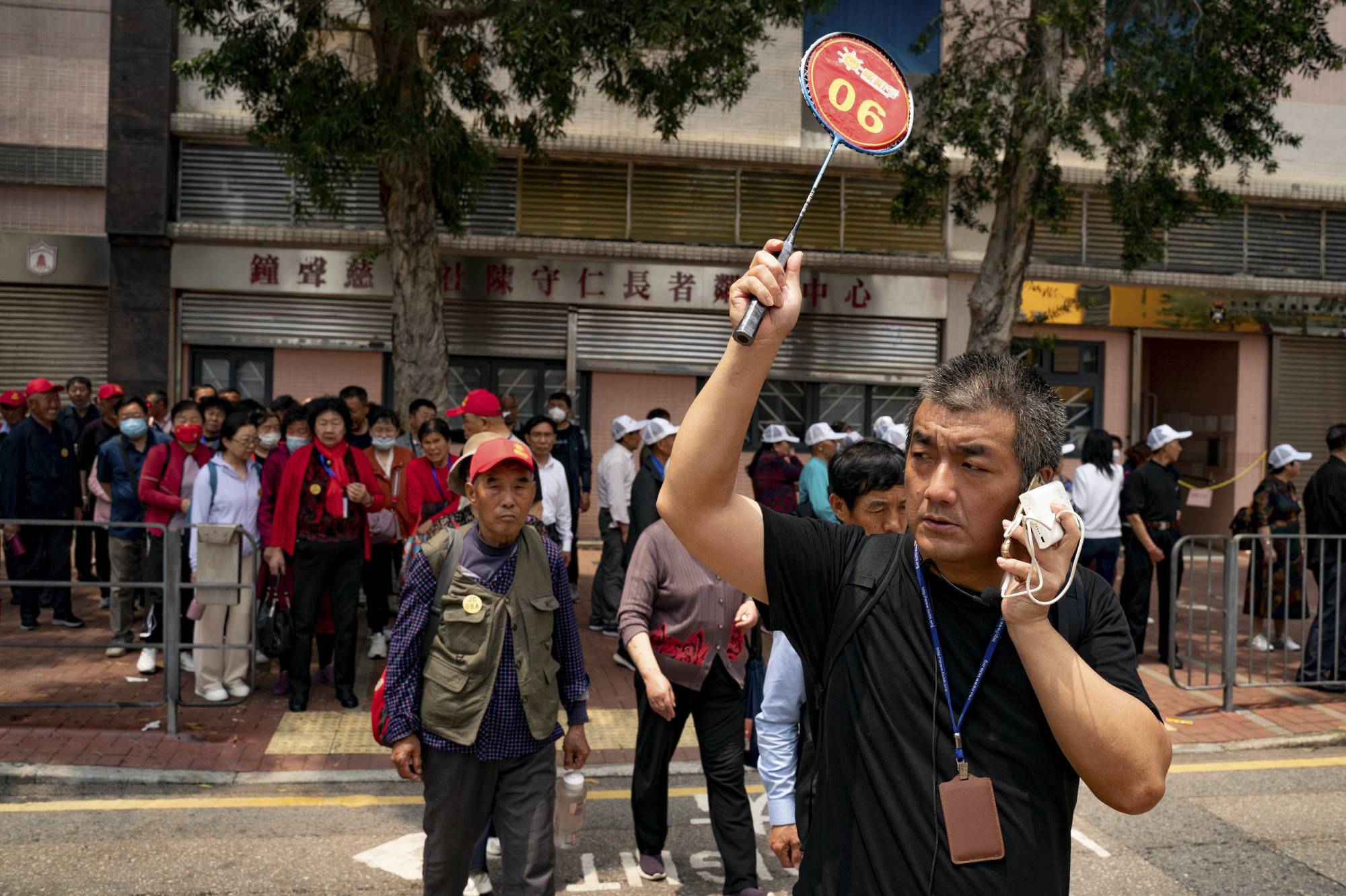 A guide leads a group of mainland Chinese tourists outside an eatery in the To Kwa Wan neighborhood of Hong Kong. | Anthony Kwan / The New York Times