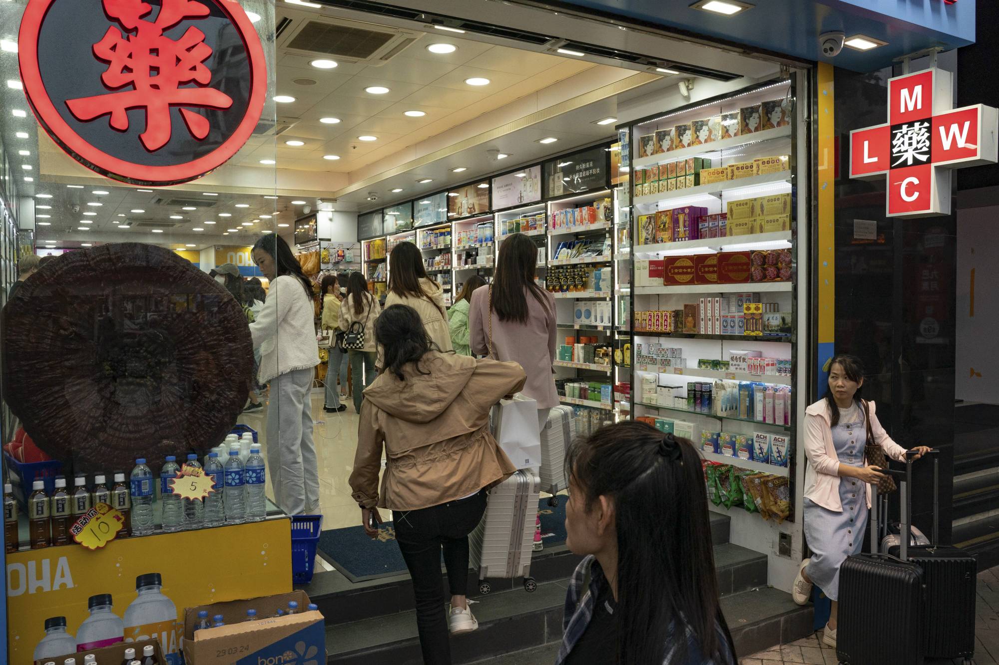 Mainland Chinese tourists shop in a pharmacy in the Tsim Sha Tsui district of Hong Kong. | Anthony Kwan / The New York Times