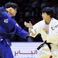 Canada\'s Christa Deguchi (left) and Japan\'s Haruka Funakubo compete in the women\'s 57-kilogram final at the World Judo Championships in Doha on Tuesday. | KYODO