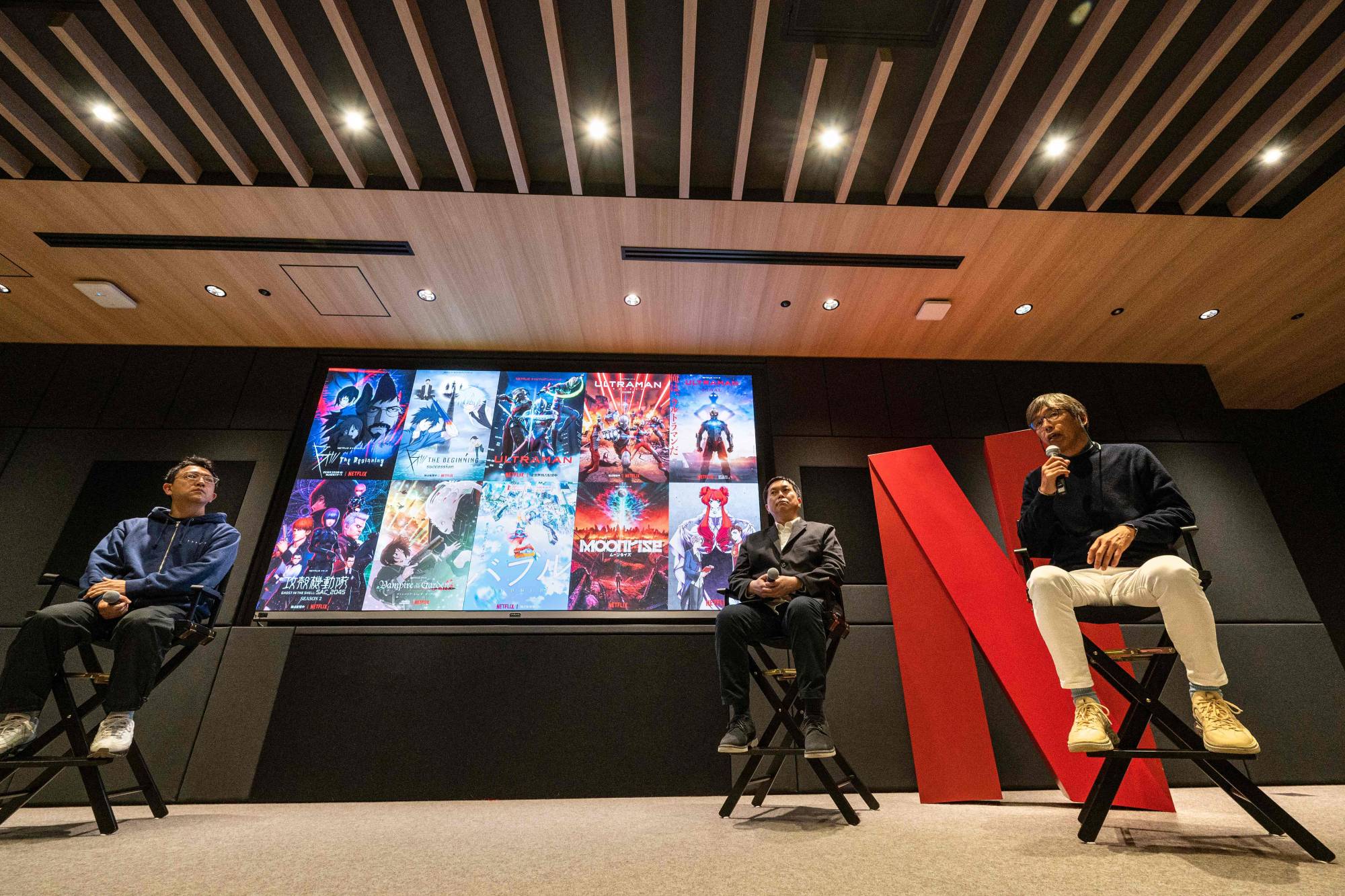 George Wada (left), the CEO of WIT Studio, and Haruyasu Makino (second from right), producer of the Netflix animated series 'Ultraman S3,' listen as Mitsuhisa Ishikawa (right), president of Production I.G, speaks during a press conference at Netflix. | AFP-JIJI