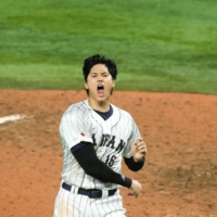 Shohei Ohtani throws his hat after striking out Mike Trout to record the last out of Japan\'s victory over the United States in the World Baseball Classic final in Miami on March 21. | USA TODAY / VIA REUTERS