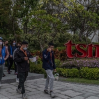 Workers exit the TSMC factory in Tainan, Taiwan, in February. The company’s employee count has grown almost 70% over the past decade, while Taiwan’s birthrate has plummeted by half. | LAM YIK FEI / THE NEW YORK TIMES