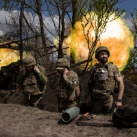 Ukrainian soldiers with a motorized brigade fire howitzers at Russian forces in the Donetsk region of Ukraine on May 6. | TYLER HICKS / THE NEW YORK TIMES