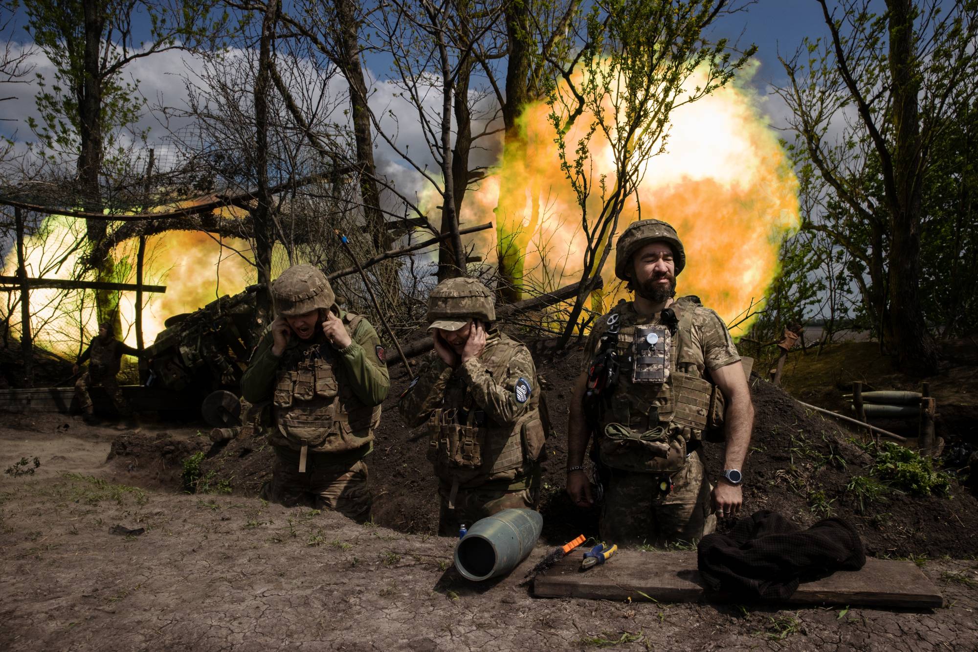 Ukrainian soldiers with a motorized brigade fire howitzers at Russian forces in the Donetsk region of Ukraine on May 6. | Tyler Hicks / The New York Times