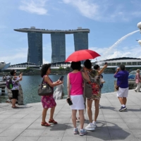 The temperature in Singapore hit 37 degrees Celsius on Saturday, matching the city-state\'s 1983 record. | AFP-JIJI