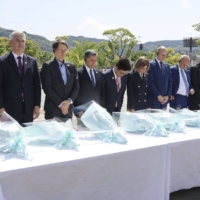 Health ministers from the Group of Seven countries take part in a moment of silence at the Nagasaki Peace Park on Sunday after wrapping up a two-day meeting. | COURTESY OF HEALTH, LABOR AND WELFARE MINISTRY / VIA KYODO