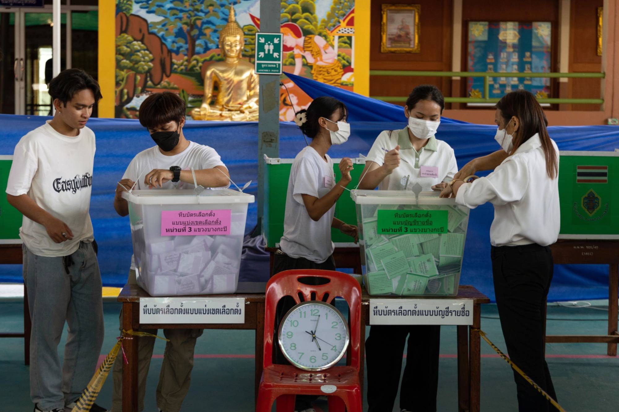 Electoral officials prepare for preliminary counting of votes at a polling station in the Phrom Phong area of Bangkok on Sunday. | Bloomberg
