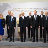 U.S. President Joe Biden, third from left in the front row, poses for a group photograph with leaders from NATO’s eastern flank in Warsaw on Feb. 22. | DOUG MILLS / THE NEW YORK TIMES