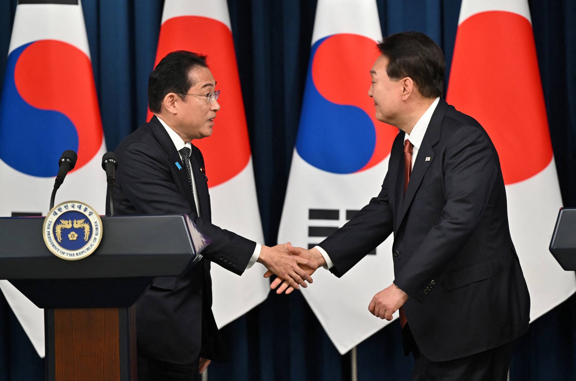 Prime Minister Fumio Kishida greets South Korean President Yoon Suk-yeol during a joint news conference after their meeting at the Presidential Office in Seoul on May 7. | Pool / via REUTERS