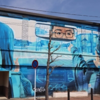 Many buildings around Futaba Station have been painted with murals, including this one representing the town as it was before the disaster. | RIN ONOZUKA