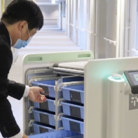 A robot delivers medicine and equipment at Toyota Memorial Hospital in Aichi Prefecture on April 10. | KYODO