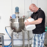 John Cree, manufacturing executive, makes skin care products at 5 Squirrels, in Hove, Britain. | REUTERS