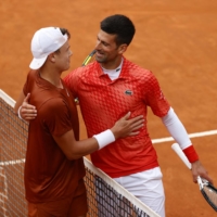 Novak Djokovic (right) embraces Holger Rune following their quarterfinal match at the Italian Open in Rome on Wednesday. | REUTERS