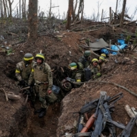 Ukrainian soldiers near the front-line city of Bakhmut, Ukraine, on May 11.  | RADIO FREE EUROPE / VIA REUTERS
