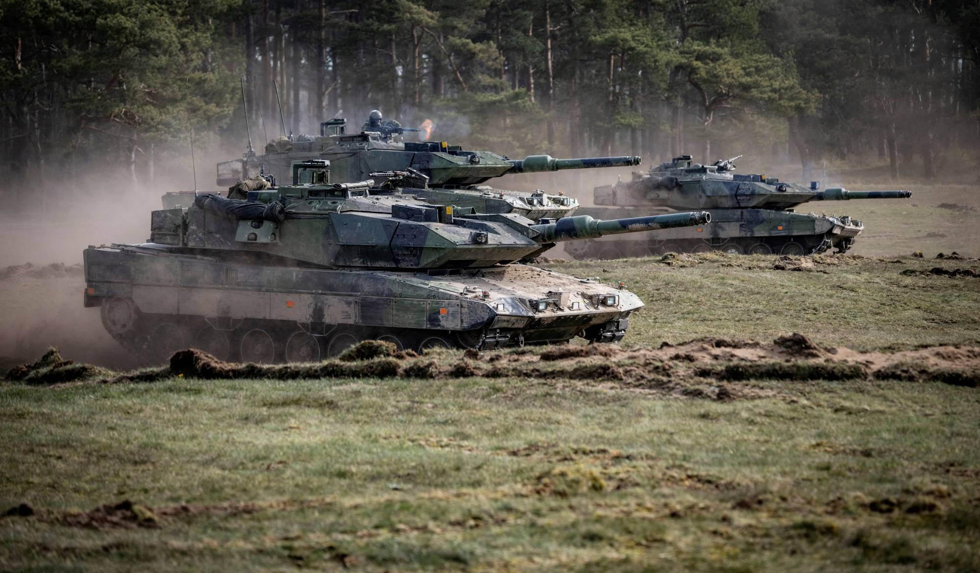 Machine guns are fired from a Swedish tank 122 as it advances towards the enemy, during the Aurora 23 military exercise earlier this year at the Rinkaby firing range outside Kristianstad, Sweden. | TT NEWS AGENCY / VIA REUTERS  