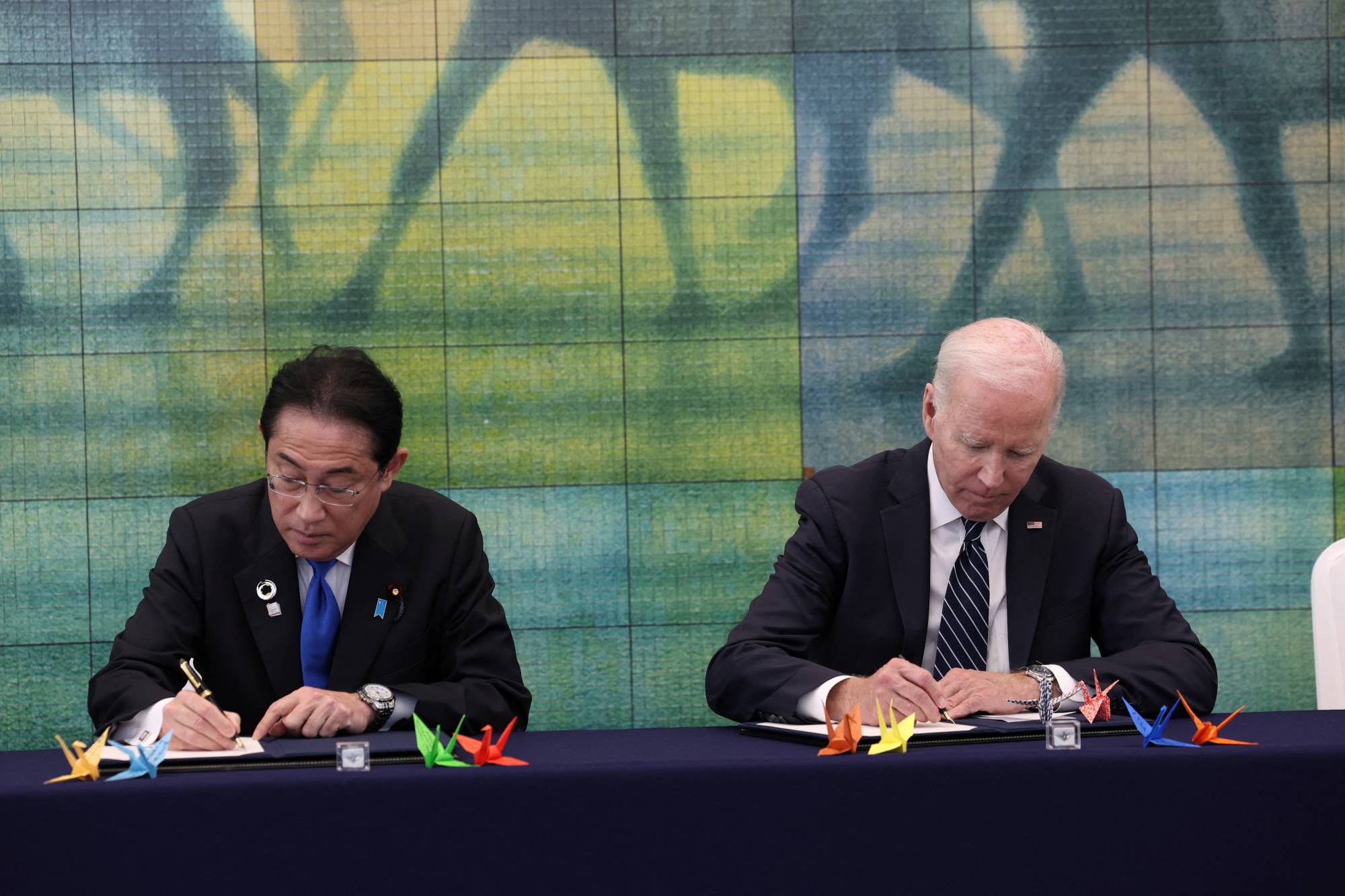 U.S. President Joe Biden and Prime Minister Fumio Kishida sign a guestbook as they visit Hiroshima Peace Memorial Museum with other G7 leaders as a part of a summit in the atomic-bombed city on Friday. | FOREIGN MINISTRY / VIA REUTERS