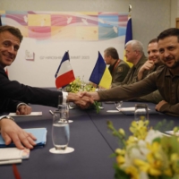 Ukrainian President Volodymyr Zelenskyy shakes hands with French President Emmanuel Macron during their bilateral meeting on the sidelines of the Group of Seven leaders\' summit in Hiroshima on Saturday. | AFP-JIJI
