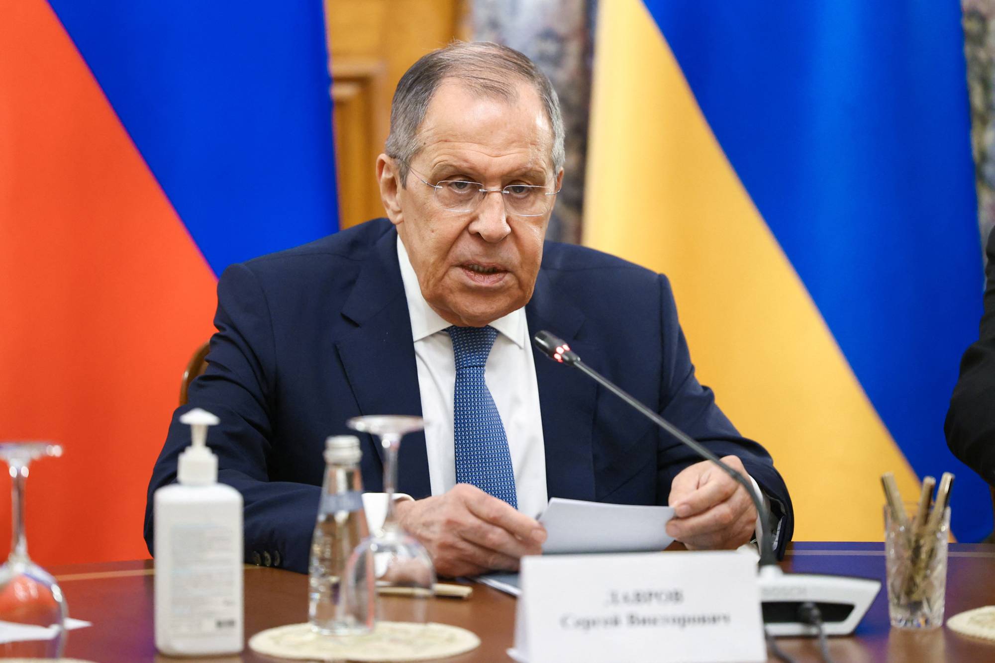 Russian Foreign Minister Sergey Lavrov reads from a prepared statement during a televised news conference Saturday | RUSSIAN FOREIGN MINISTRY / VIA REUTERS