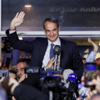 Greek Prime Minister and New Democracy conservative party leader Kyriakos Mitsotakis waves outside the party\'s headquarters in Athens on Sunday, after a general election. | REUTERS