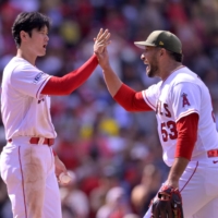 Angels two-way star Shohei Ohtani (left) and reliever Carlos Estevez celebrate after their victory over the Twins at Angel Stadium in Anaheim on Sunday. | USA TODAY / VIA REUTERS