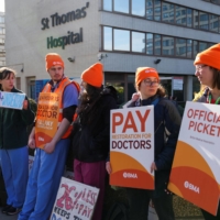 Junior doctors strike over low pay and poor working conditions outside a hospital in London on April 11. | REUTERS