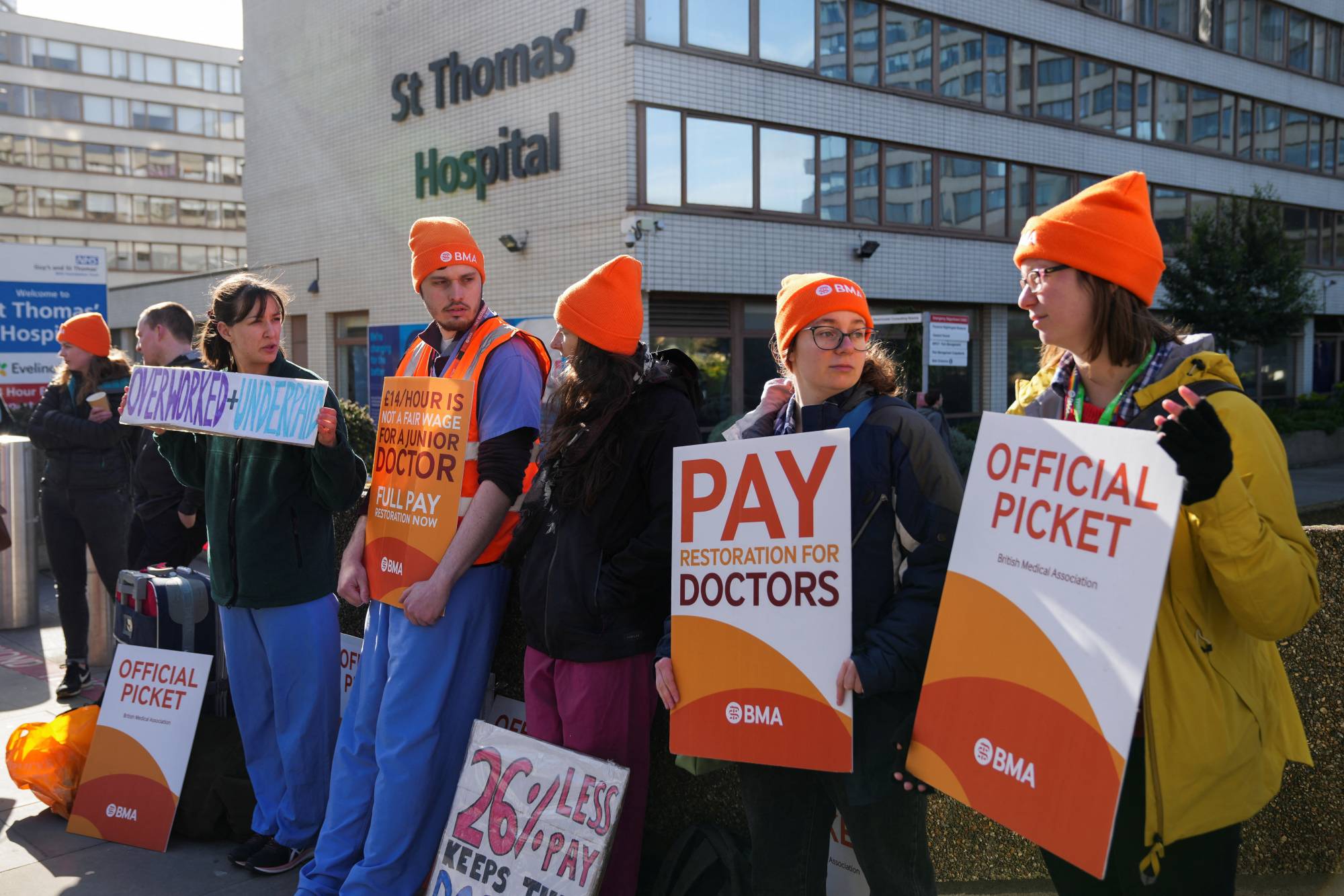 Junior doctors strike over low pay and poor working conditions outside a hospital in London on April 11. | REUTERS
