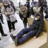 Local residents take part in an earthquake drill in the city of Kushiro, Hokkaido, in February. | KYODO
