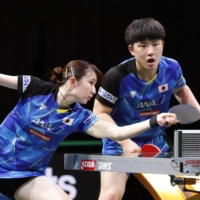 Hina Hayata (left) and Tomokazu Harimoto compete during the mixed doubles semifinals at the world table tennis championships in Durban, South Africa, on Thursday. | KYODO
