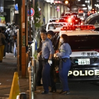 Police near the scene of a shooting in Machida, western Tokyo, on Friday night.  | KYODO 