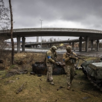 Ukrainian soldiers inspect the remains of a Russian tank in Stoyanka, Ukraine, in April last year | IVOR PRICKETT / THE NEW YORK TIMES

