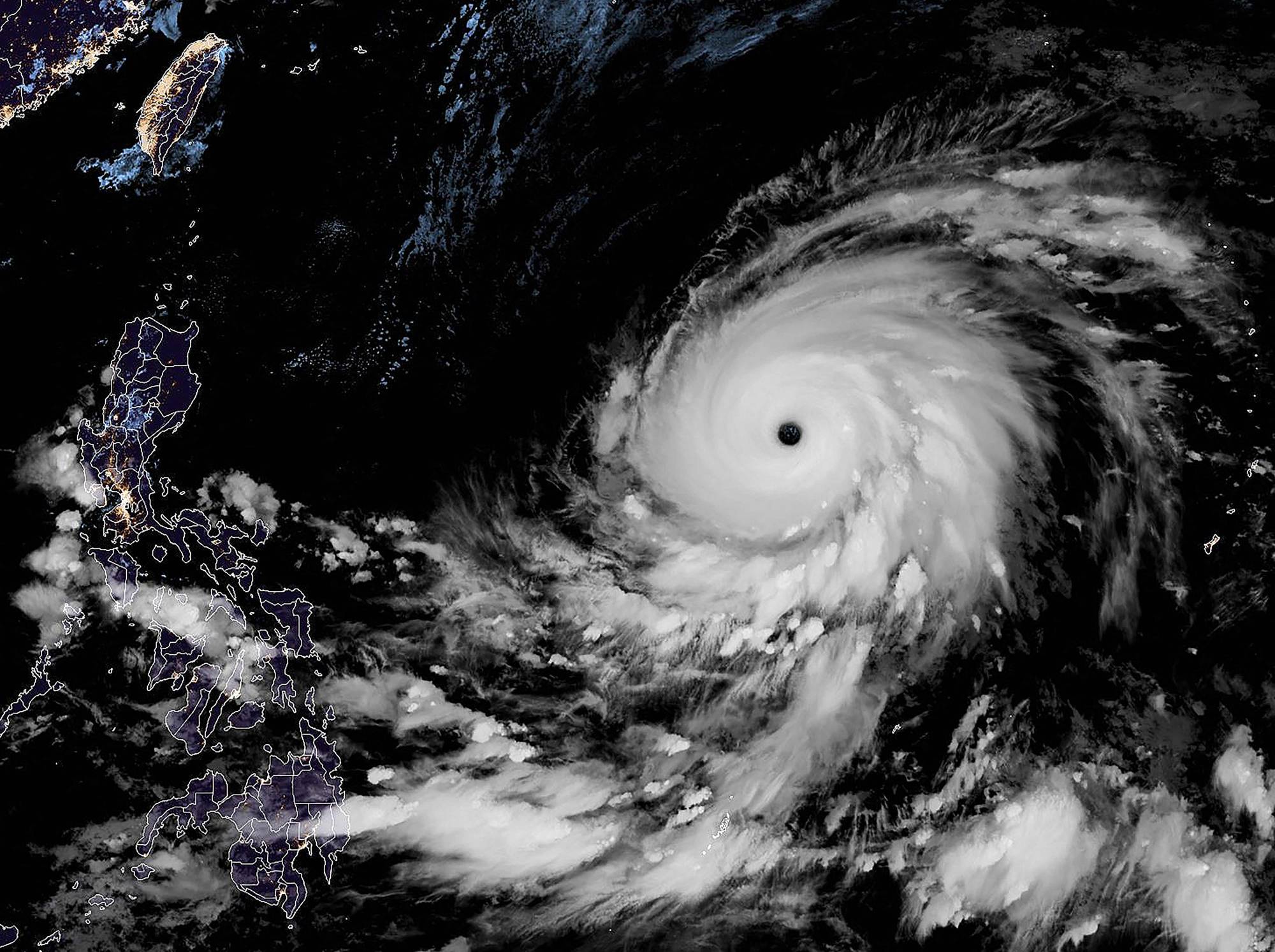 A satellite image shows Super Typhoon Mawar as it moves away from Guam on Friday and toward the Philippines.  | NOAA / RAMMB / VIA AFP-JIJI