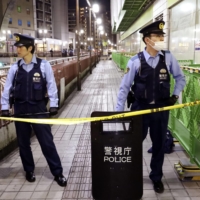 Police at the crime scene near Machida Station after a fatal shooting Friday night.  | KYODO 