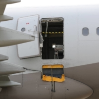 An Asiana Airlines plane upon which a passenger opened an emergency door shortly before the plane landed at Daegu Airport on Friday.  | YONHAP / VIA REUTERS 