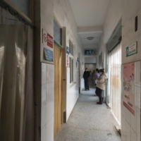 Patients wait in the hallway of a community health center in Niutun, China, in January.  | QILAI SHEN / THE NEW YORK TIMES