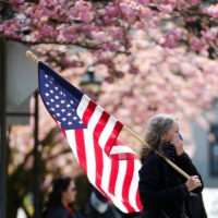 A woman attends a rally in Olympia, Washington, to protest the state\'s COVID-19 extended stay-at-home order in April 2020. | REUTERS